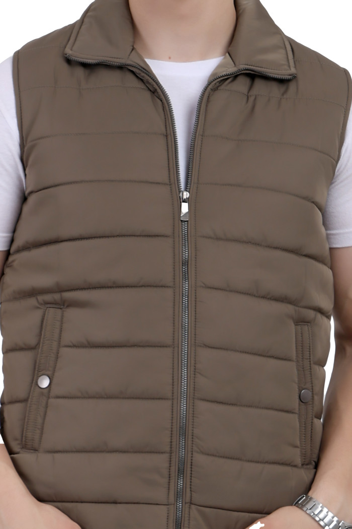 A cropped image of a woman wearing a Mouse half jacket with a high neck ,zipper closure and pocket designed for casual winter layering and comfort.