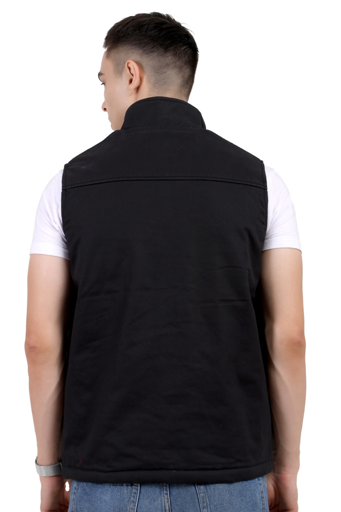 A back pose of a man wearing a Black half jacket with a high neck ,zipper closure and pocket designed for casual winter layering and comfort.