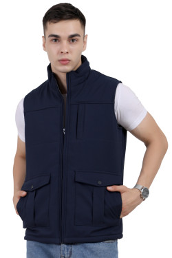 A man wearing a navy half jacket with a high neck, zipper closure and pocket in hand designed for casual winter layering and comfort.