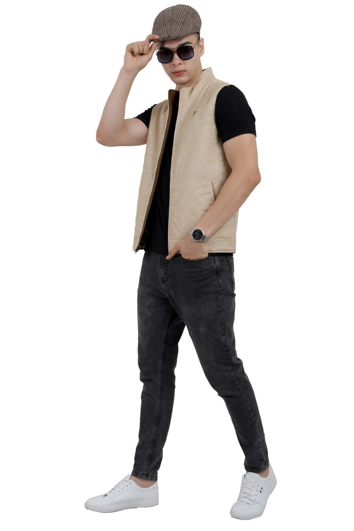 :A tilted pose of a man wearing a Khaki half jacket with a high neck, zipper closure and pocket in hand designed for casual winter layering and comfort.