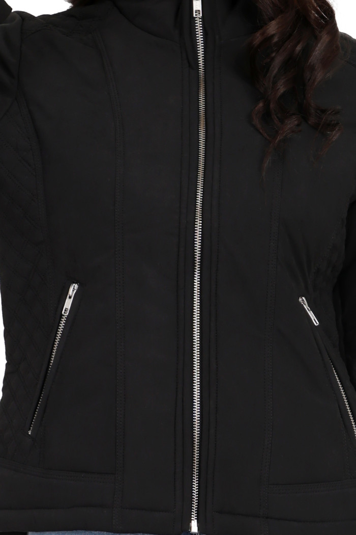 A cropped image of a woman wearing Trufit’s black quilted biker jacket with a Chinese collar, sliver zip closure and side pockets with a silver zipper.