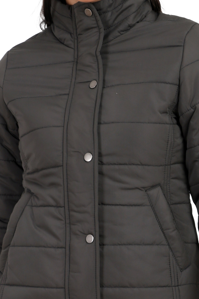 A cropped image of a woman wearing Trufit’s olive quilted jacket without a hood with a high neck, zip closure, button placket, and side pockets.