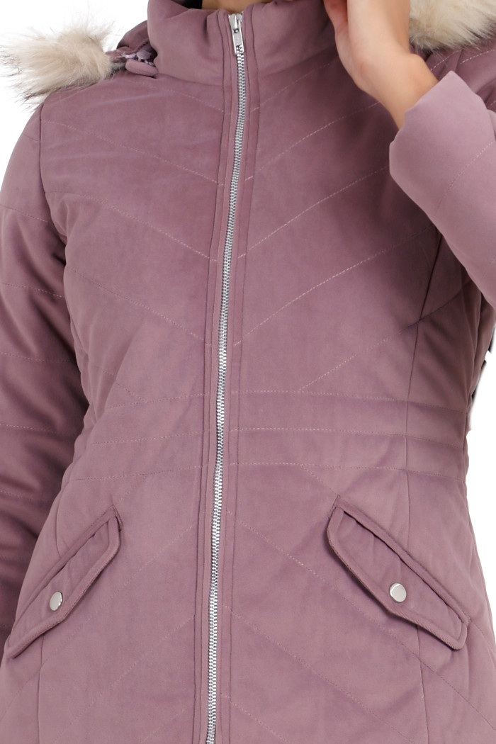 A cropped image of a woman wearing Coatsnmore’s lilace velvet quilted jacket with a high neck, zip closure, removable hood with faux fur trim, and slash pockets.