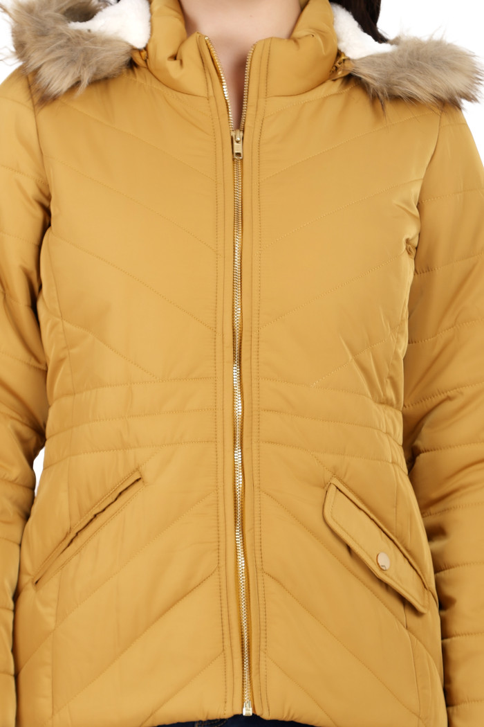 A cropped shot of a woman wearing Coatsnmore’s casual jacket in mustard colour with a textured pattern, slash placket pockets, a zip closure and a detachable hood.