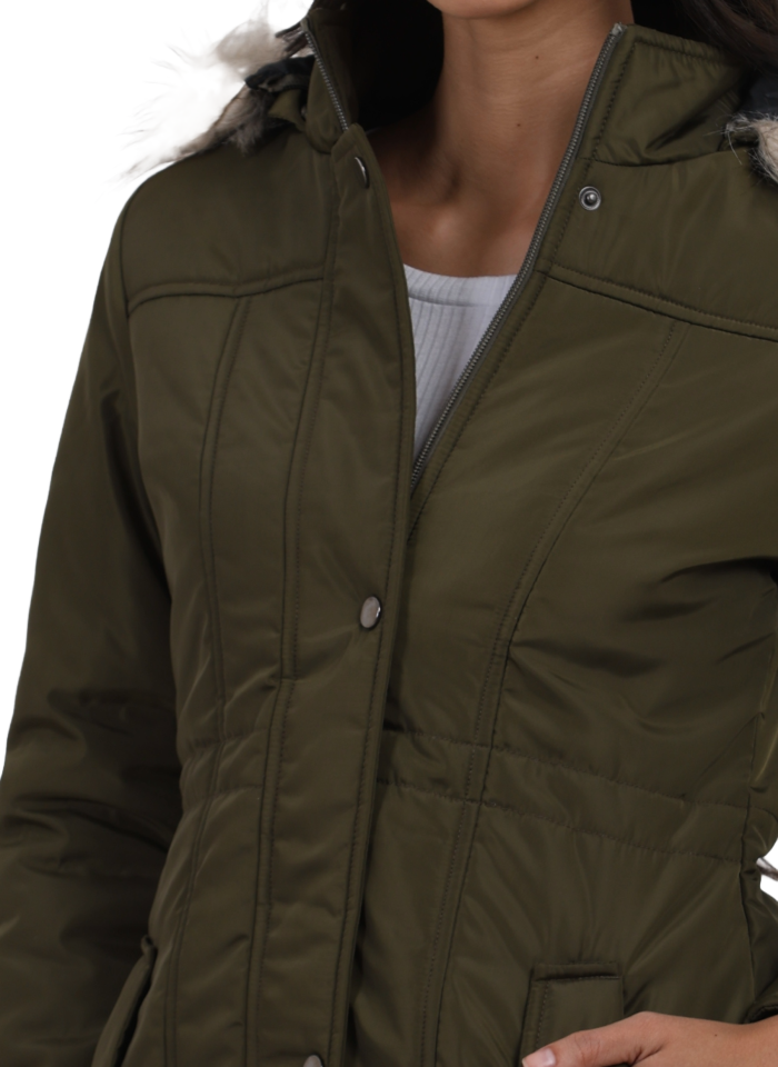 A woman in a cropped image is wearing Coatsnmore’s Olive quilted parka jacket with a detachable hood, zip closure, button placket, side pockets and quilted pattern with her left hand in the pocket.