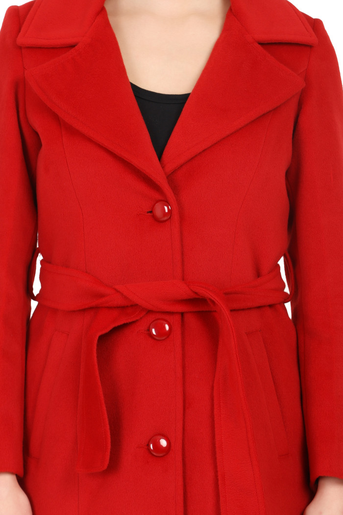 A cropped frame captures a woman dressed in Coatsnmore’s long red tweed coat with a belt featuring a lapel collar, button-up design and side pockets.