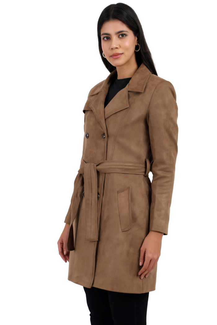 A woman is holding a standing side pose, wearing Coatsnmore’s mouse double-breasted trench coat with a lapel collar, button closure, belt, side pockets, and black bottoms.