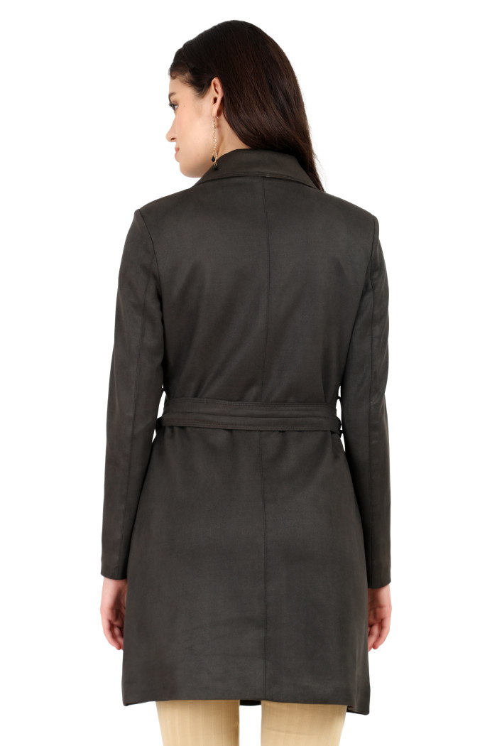 A back pose of a standing woman wearing Coatsnmore’s olive double-breast trench coat with a belt and bottom.