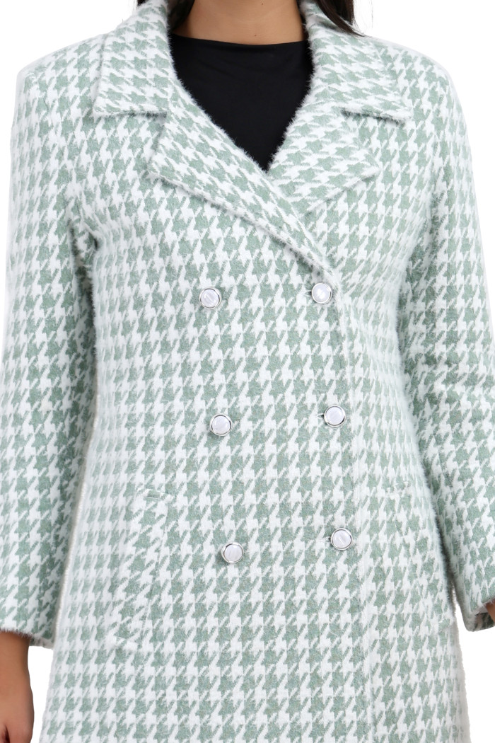 A cropped frame captures a woman dressed in Coatsnmore’s green double-breasted semi-long coat featuring a lapel collar, button-up design and side pockets.