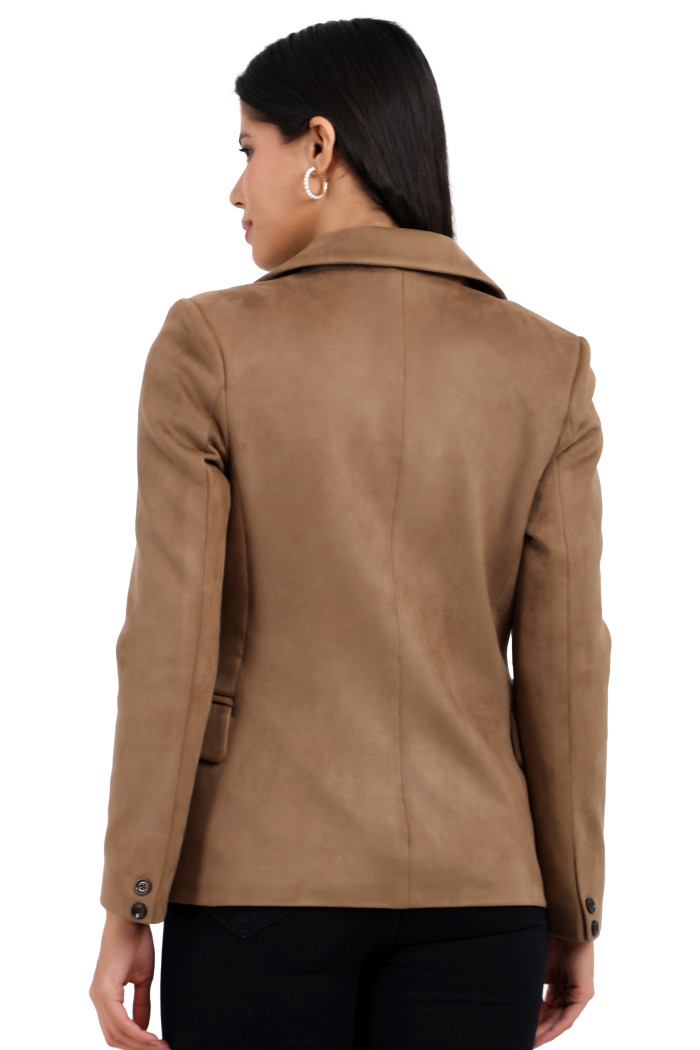 in her left hand. A back pose of a standing woman wearing Trufit’s short-length coat in olive with a lapel collar and one piece.