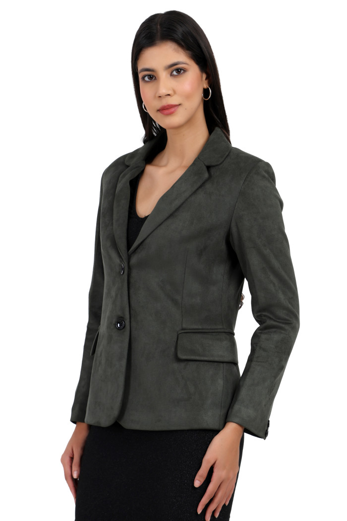 A standing pose of a woman wearing Trufit’s short-length coat in olive with a lapel collar, side pockets, and a button closure in one piece.