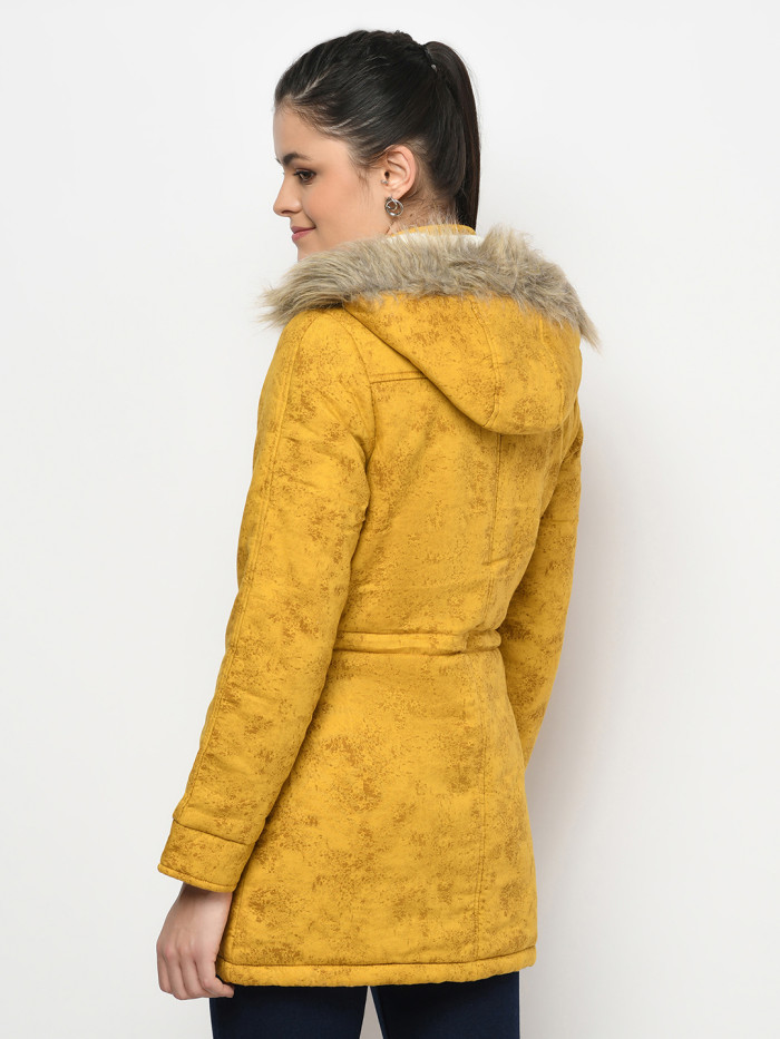 A back pose of a woman wearing a Mustard Puffer jacket with a high neck, and matching hood designed for casual winter layering and comfort.