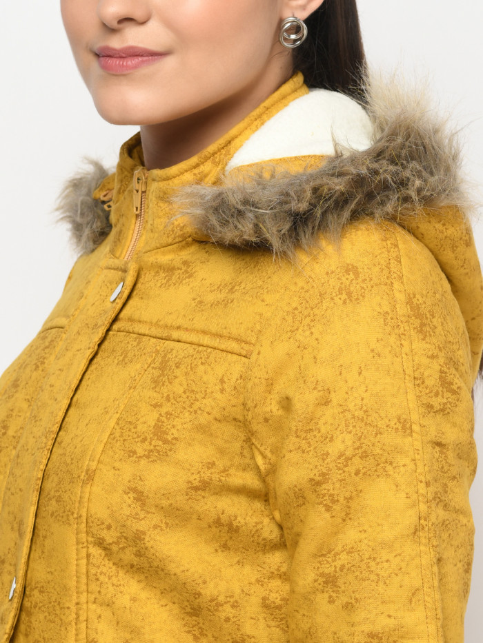 A cropped image of a woman wearing a Mustard Puffer jacket with a high neck, and matching hood designed for casual winter layering and comfort.