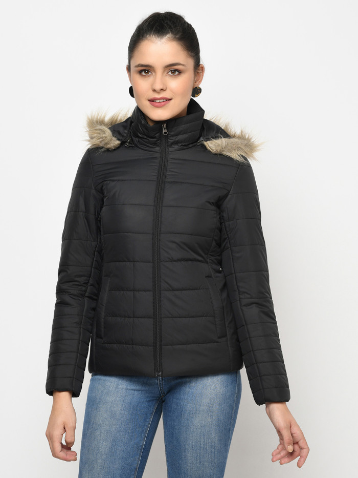 A cropped image of a woman wearing a Black Puffer jacket with a high neck, and matching hood designed for casual winter layering and comfort.