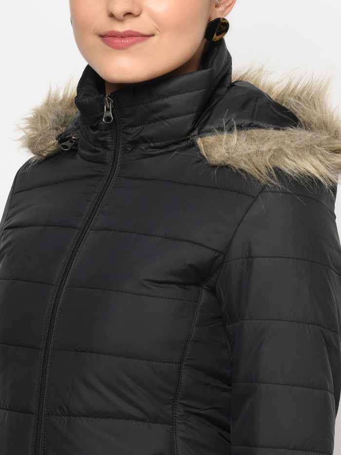 A cropped image of a woman wearing a Black Puffer jacket with a high neck, and matching hood designed for casual winter layering and comfort.