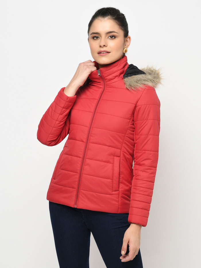 A cropped image of a woman wearing a Red Puffer jacket with a high neck, and matching hood designed for casual winter layering and comfort.