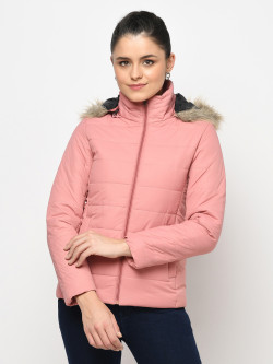 A cropped image of a woman wearing a Lt. Pink Puffer jacket with a high neck, and matching hood designed for casual winter layering and comfort.