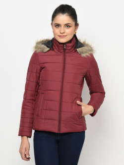 A cropped image of a woman wearing a Maroon Puffer jacket with a high neck, and matching hood designed for casual winter layering and comfort.