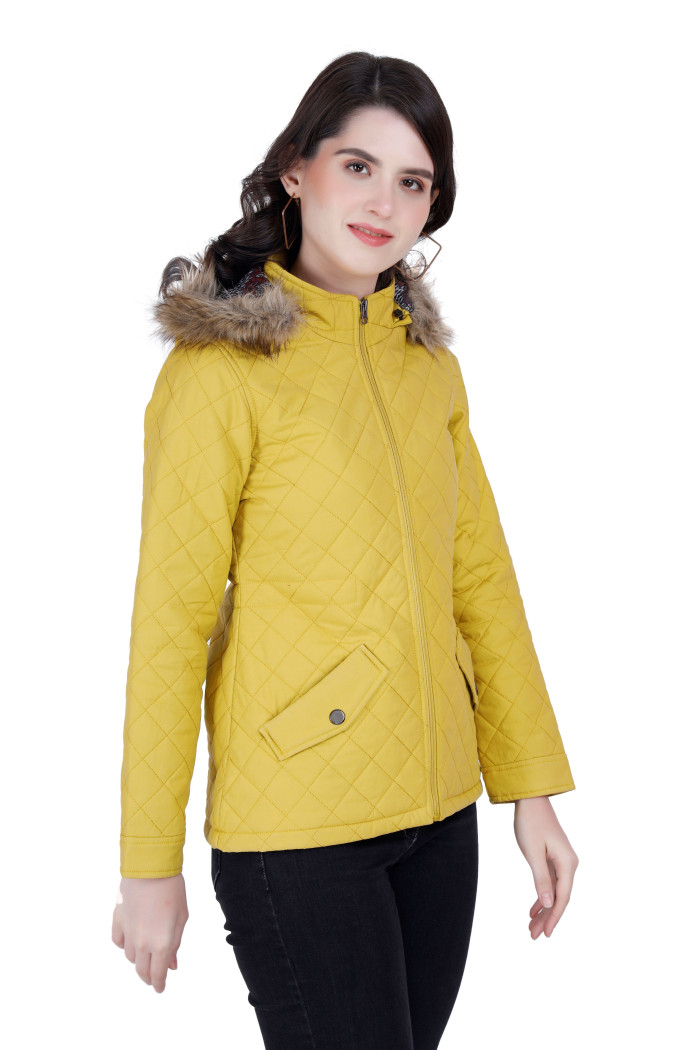 A left pose of a woman wearing a Mustard Quilted Jacket with a high neck, hood, zipper closure and pocket in hand designed for casual winter layering and comfort.