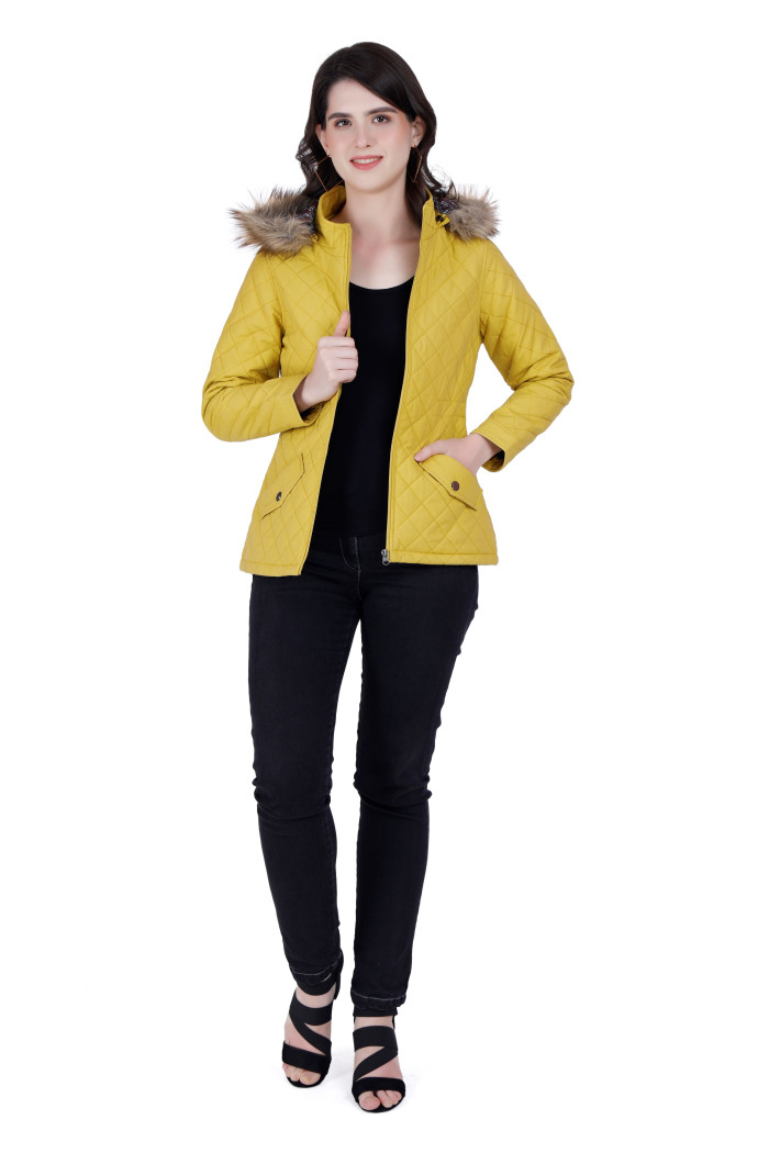 A woman wearing a Mustard Quilted Jacket with a high neck, hood, zipper closure and pocket in hand designed for casual winter layering and comfort.