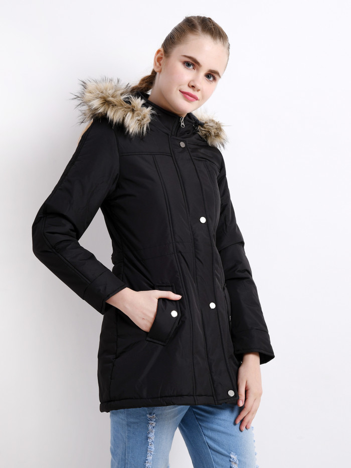 A left pose of a woman wearing a Black puffer jacket with a high neck, hood, zipper closure and pocket in hand designed for casual winter layering and comfort.