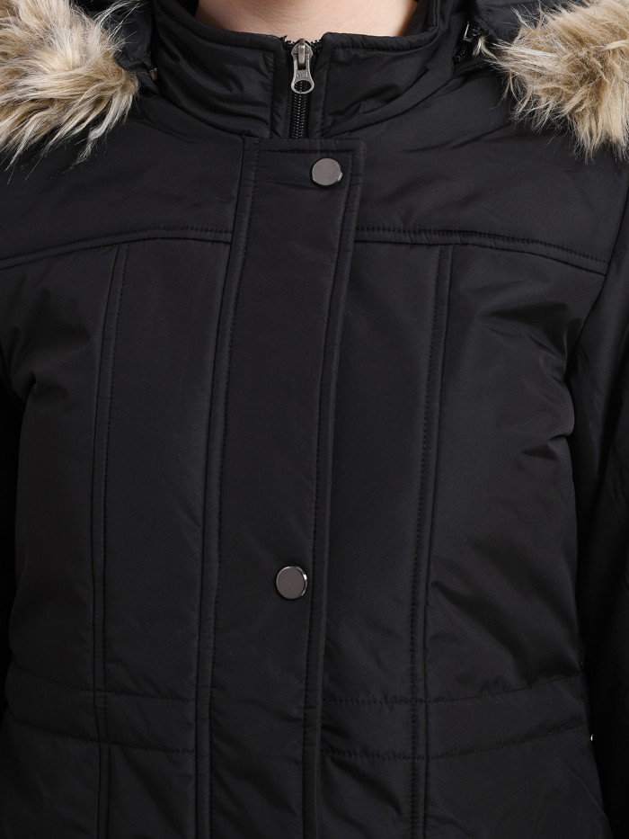 A cropped image of a woman wearing a Black Puffer jacket with a high neck, and matching hood designed for casual winter layering and comfort.