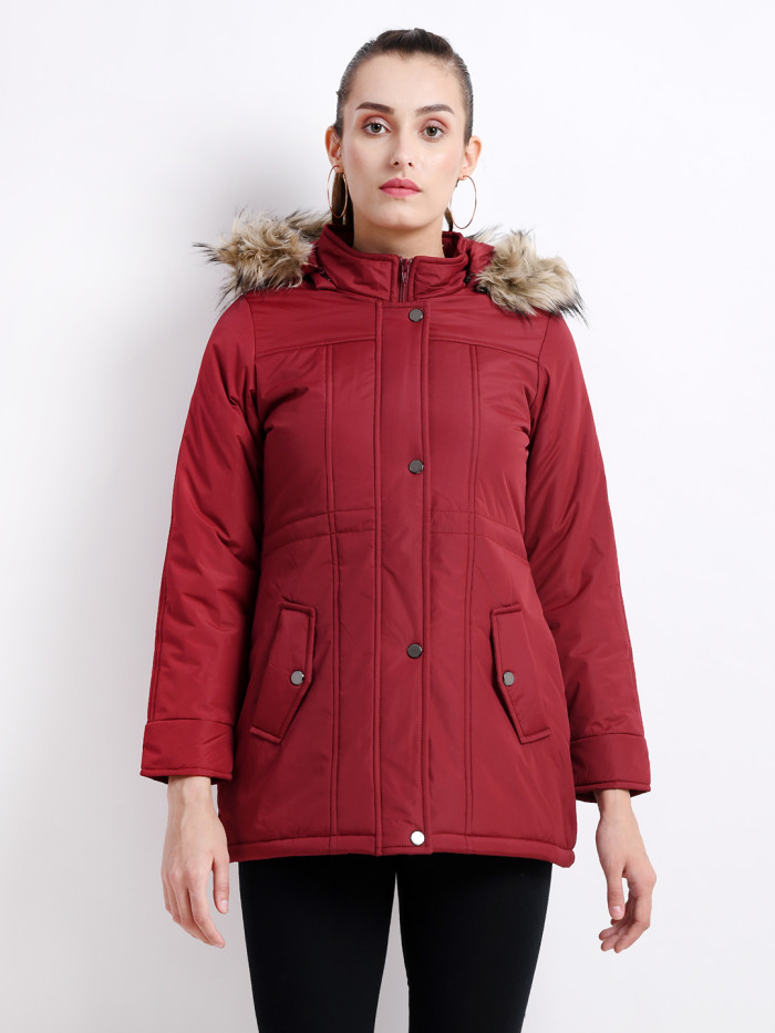 A cropped image of a woman wearing a Plum Puffer jacket with a high neck, and matching hood designed for casual winter layering and comfort.