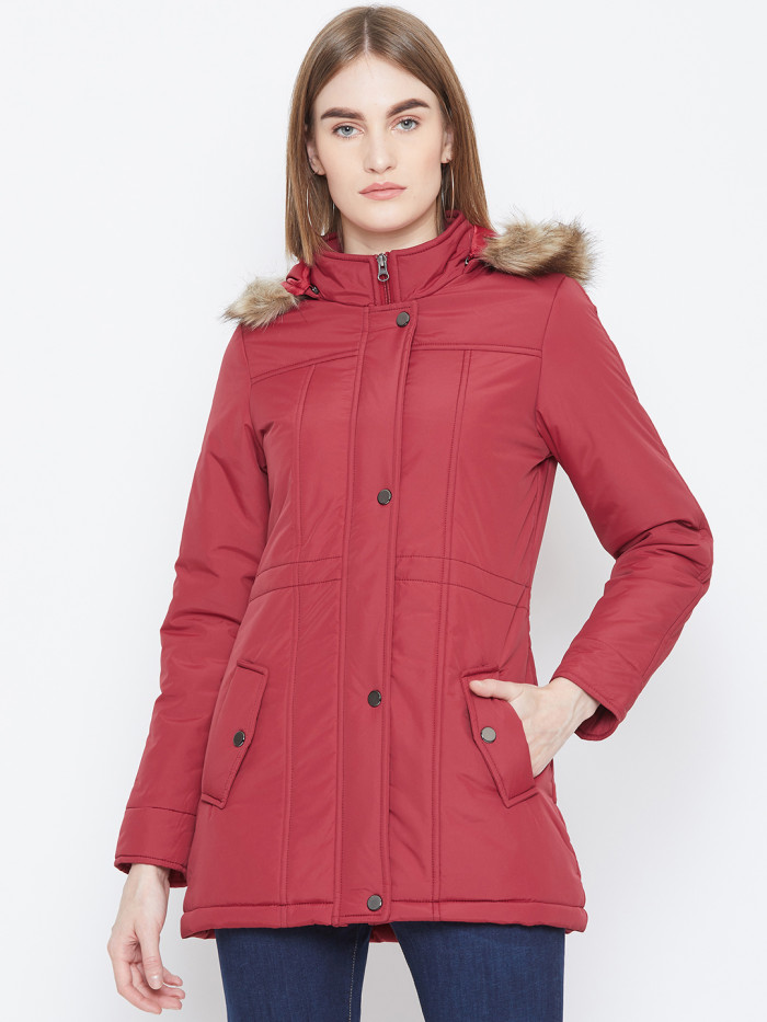 A cropped image of a woman wearing a Red Puffer jacket with a high neck, and matching hood designed for casual winter layering and comfort.