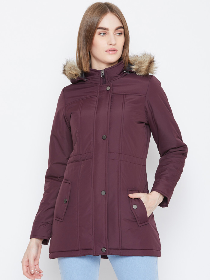 A cropped image of a woman wearing a Wine Puffer jacket with a high neck, and matching hood designed for casual winter layering and comfort.