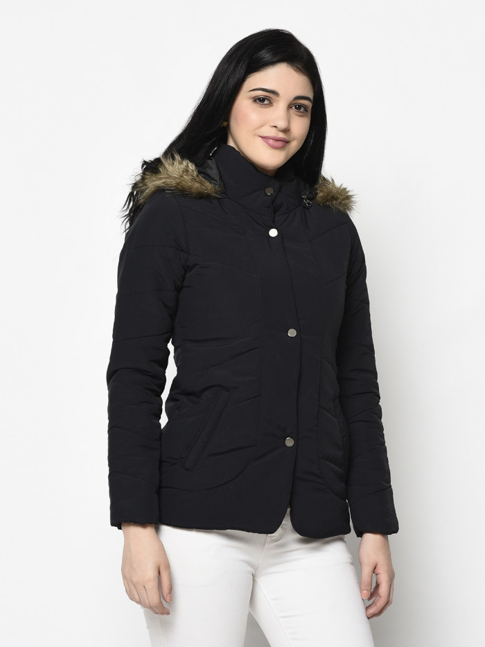 A left pose of a woman wearing a Black Quilted Jacket with a high neck, hood, zipper closure and pocket in hand designed for casual winter layering and comfort.