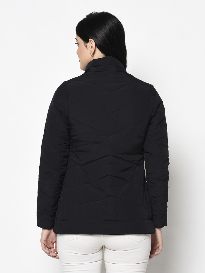 A back pose of a woman wearing a Black Quilted Jacket with a high neck, and matching hood designed for casual winter layering and comfort.