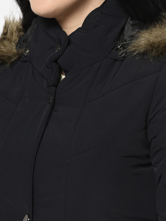 A cropped image of a woman wearing a Black Quilted Jacket with a high neck, and matching hood designed for casual winter layering and comfort.