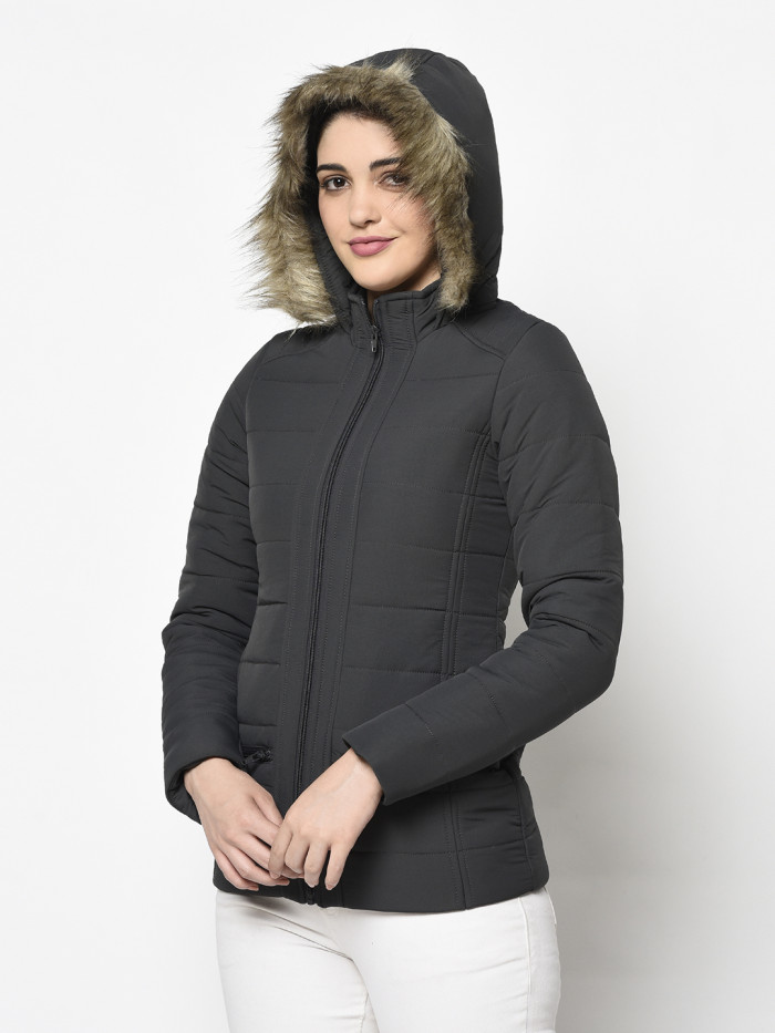 A right pose of a woman wearing a Dark Grey Puffer jacket with a high neck, hood, zipper closure and side pocket designed for casual winter layering and comfort.