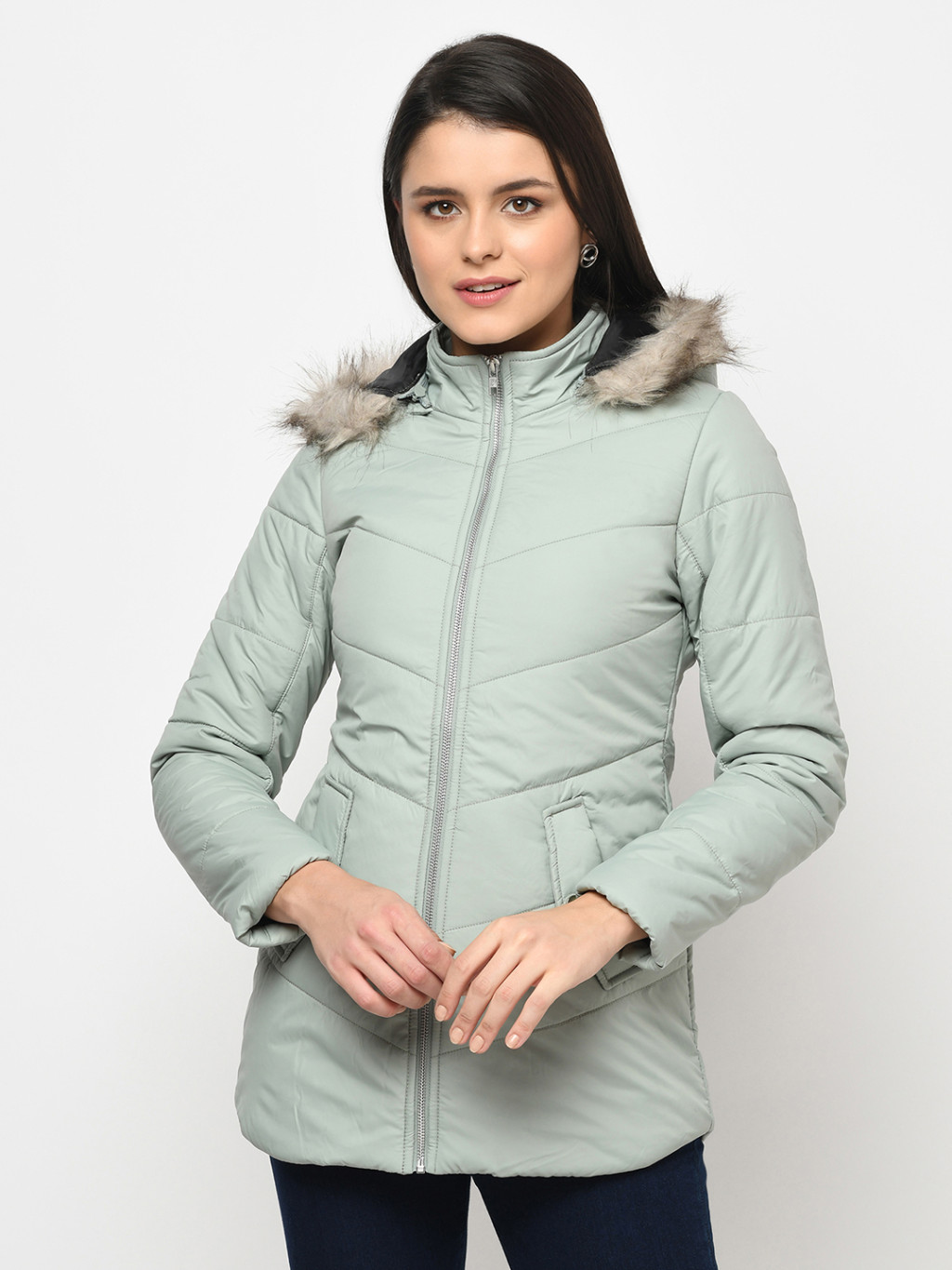 A woman wearing mint green puffer