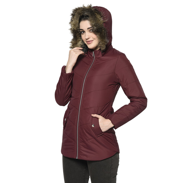 A right pose of a woman wearing a Maroon Puffer jacket with a high neck, hood, zipper closure and side pocket designed for casual winter layering and comfort.