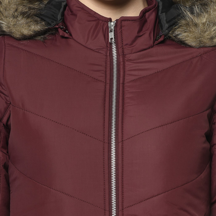 A cropped image of a woman wearing a Maroon Puffer jacket with a high neck, and matching hood designed for casual winter layering and comfort.