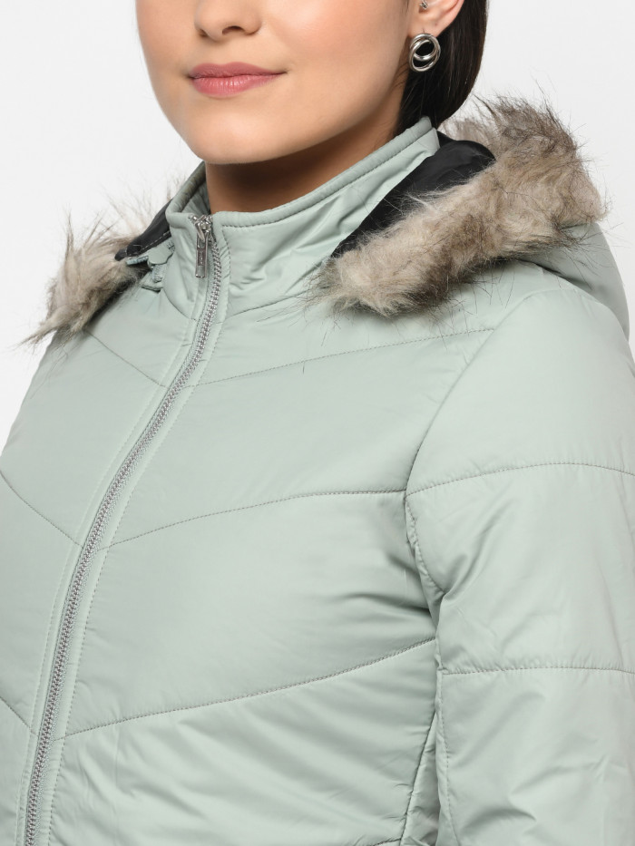 A cropped image of a woman wearing a Mint Green Puffer jacket with a high neck, and matching hood designed for casual winter layering and comfort.