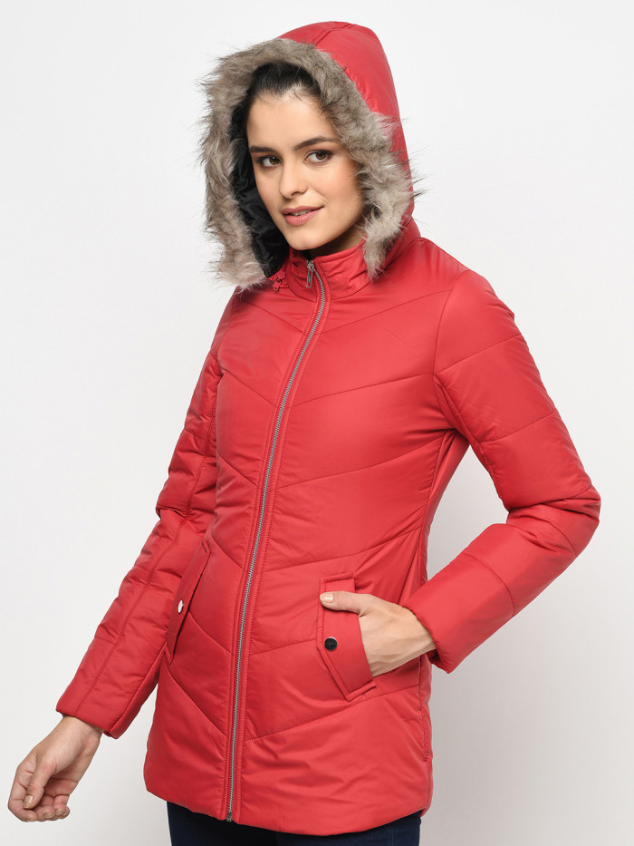 A right pose of a woman wearing a Red Puffer jacket with a high neck, hood, zipper closure and side pocket designed for casual winter layering and comfort.