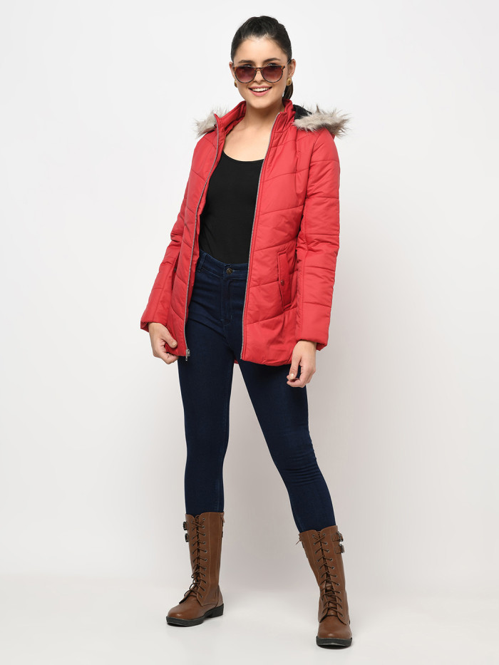 A woman wearing a Red Puffer jacket with a high neck, hood, zipper closure and pocket in hand designed for casual winter layering and comfort.