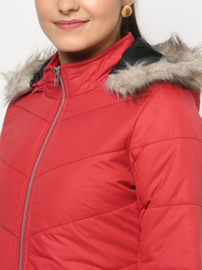 A cropped image of a woman wearing a Red Puffer jacket with a high neck, and matching hood designed for casual winter layering and comfort.