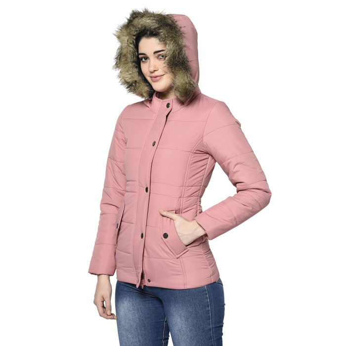 A left pose of a woman wearing a Light Pink pufferjacket with a high neck, hood, zipper closure and pocket in hand designed for casual winter layering and comfort.