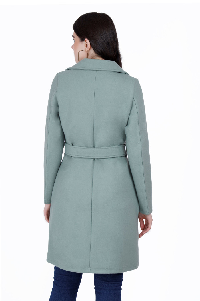 A back pose of a woman wearing a Pista Long Coat with a lapel collar and matching belt designed for formal and casual winter layering and comfort.