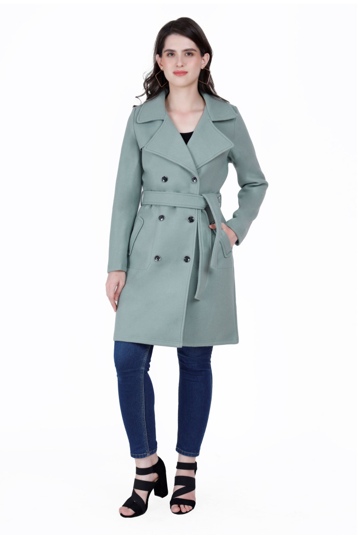 A woman wearing a Pista Long Coat with lapel collar, belt, button closure and pocket in hand designed for formal and casual winter layering and comfort.