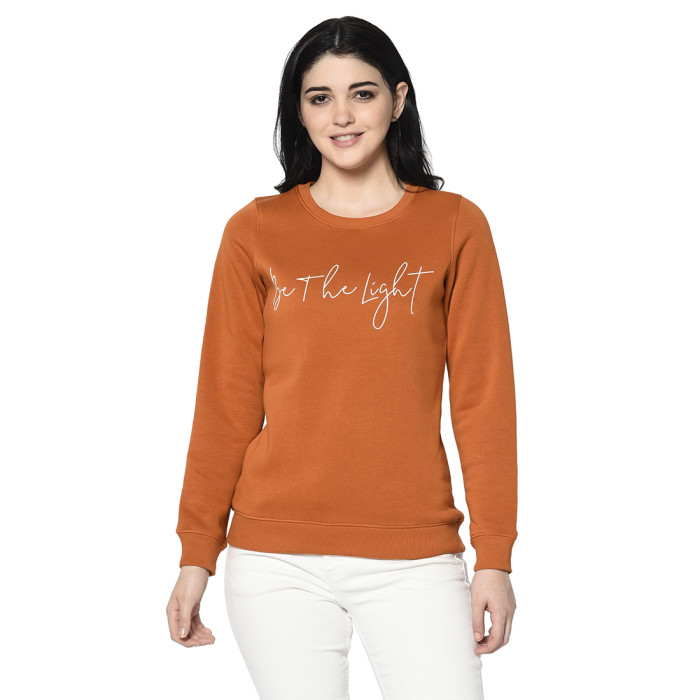 A woman wearing an Orange Sweatshirt with round neck and ribbed cuff designed for mild winter.