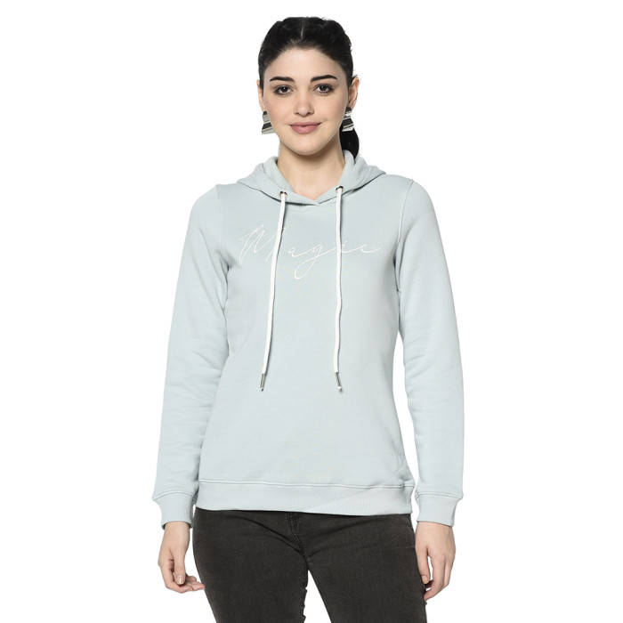 A woman wearing a Sky Hoodie with ribbed cuff, drawstring and pocket in hand designed for mild winter.